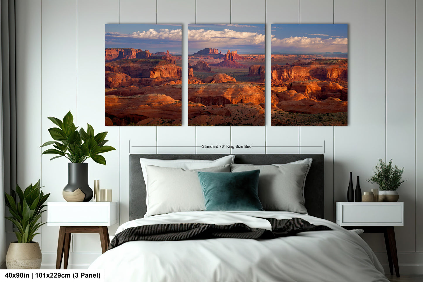 a bed in a room with two pictures on the wall