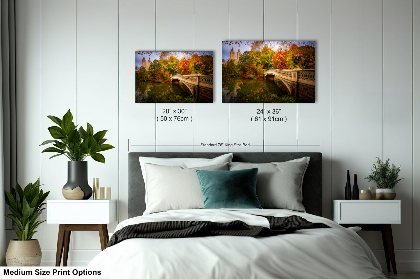 a bedroom with a bed, nightstands, and potted plants. There are two framed landscape photographs hanging on the wall above the bed, depicting a scenic outdoor view. The photographs are of different sizes, with one being larger than the other. The bed is positioned in the center of the room, and the nightstands are on either side of it. The room has a minimalist and modern design, with white walls and a gray floor.