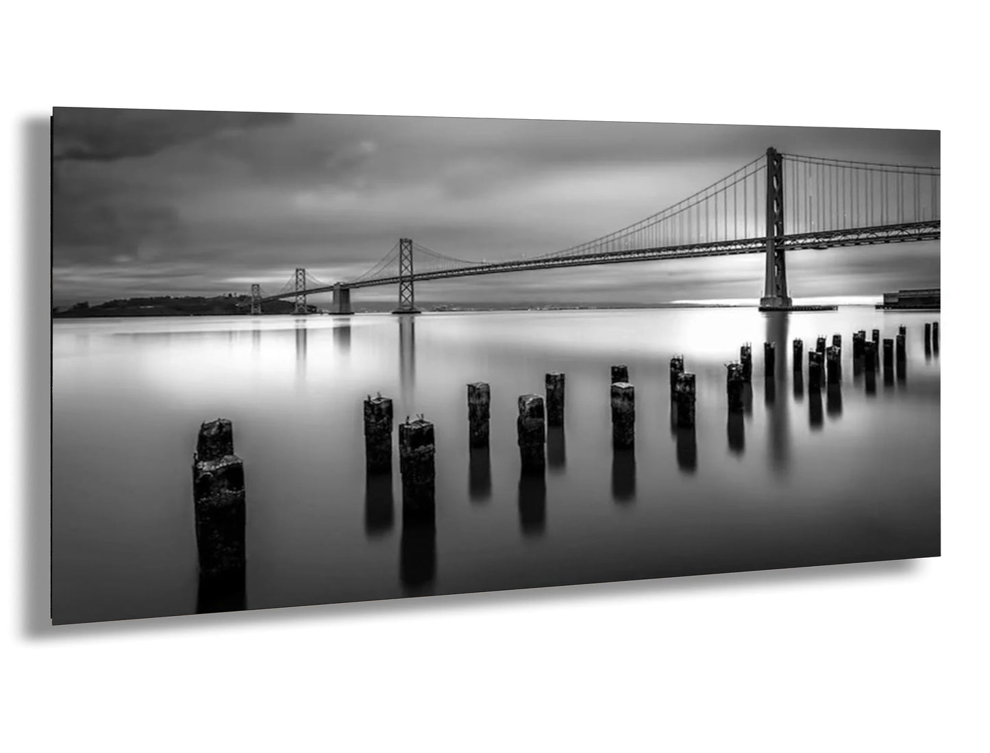 a black and white photo of a bridge over water