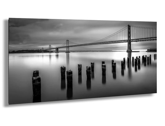 a black and white photo of a bridge over water