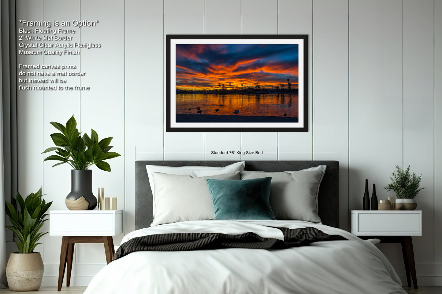 a bedroom with a large bed, nightstands, and a framed picture of a sunset over a body of water.