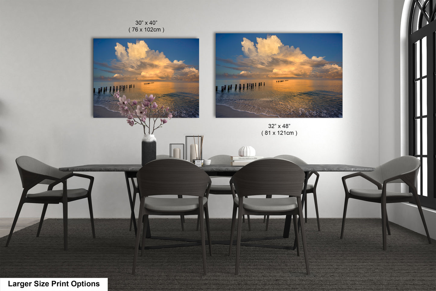 a dining room table with four chairs and a vase of flowers