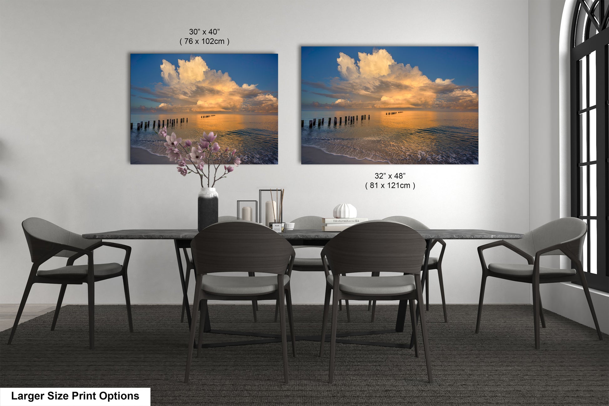 a dining room table with four chairs and a vase of flowers