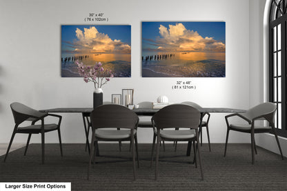 a dining room table with four chairs and a vase of flowers
