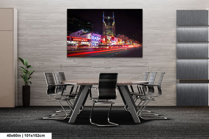 a dining room table with chairs and a painting on the wall