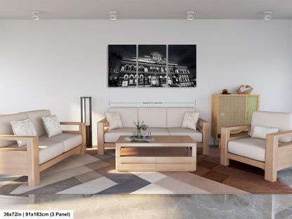 a living room filled with furniture and a painting on the wall