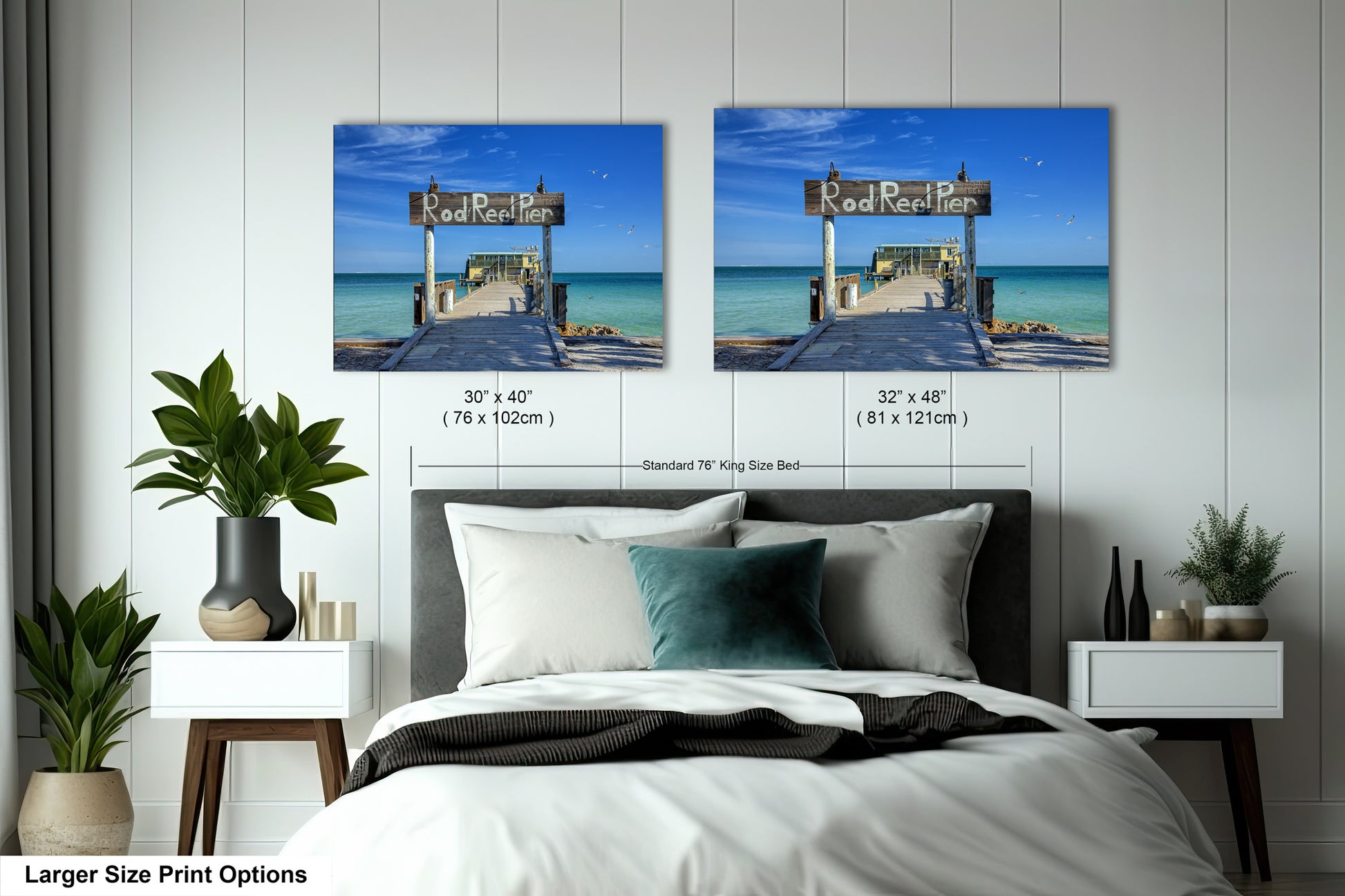 a bed with two pictures on the wall above it