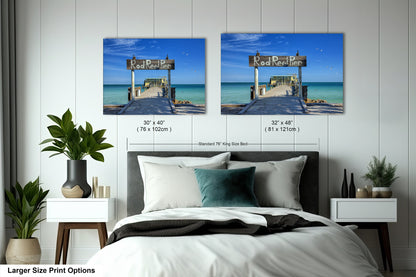 a bed with two pictures on the wall above it