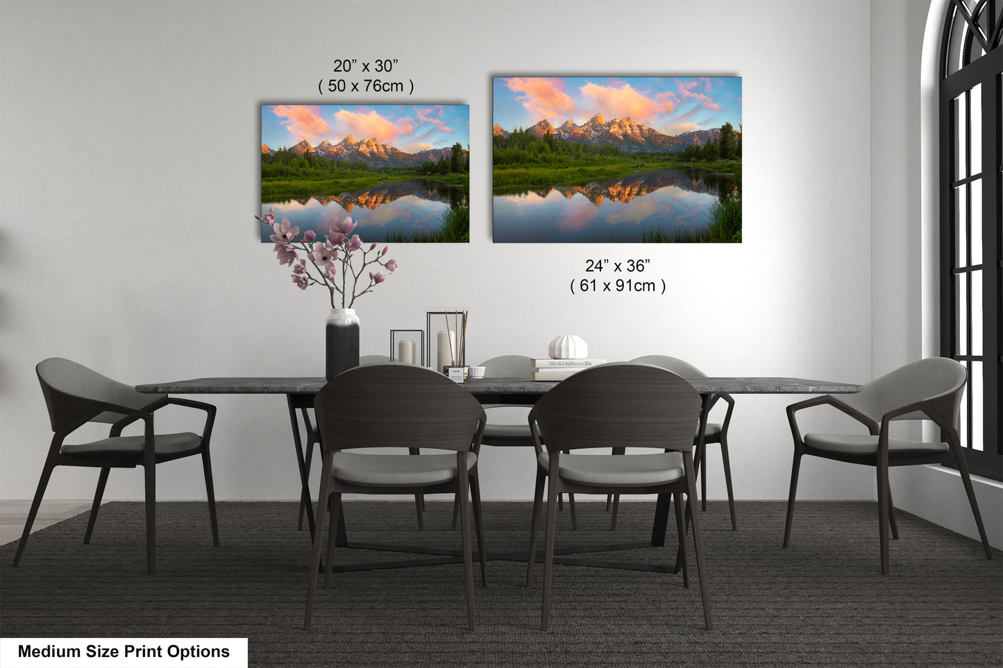 a dining table with four chairs and a vase with flowers