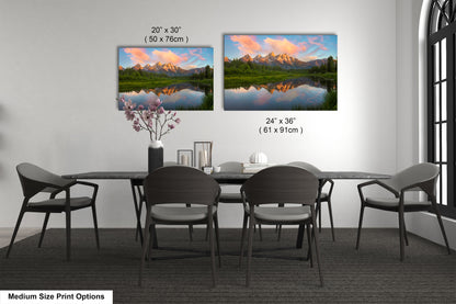 a dining table with four chairs and a vase with flowers