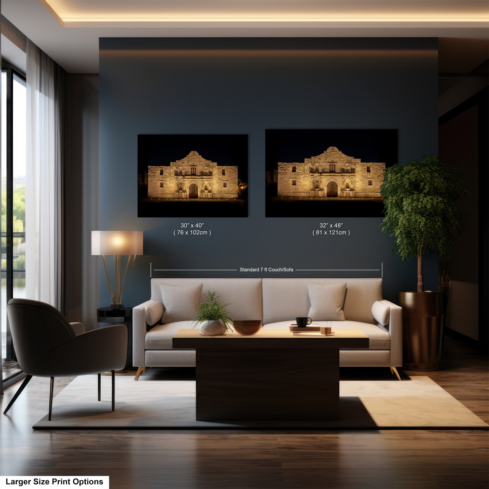a modern living room with a large sofa, a coffee table, and a lamp. Two framed prints of the Alamo in San Antonio, Texas, are displayed on the wall above the sofa.