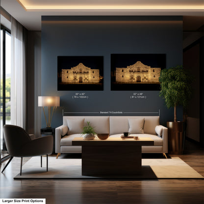 a modern living room with a large sofa, a coffee table, and a lamp. Two framed prints of the Alamo in San Antonio, Texas, are displayed on the wall above the sofa.