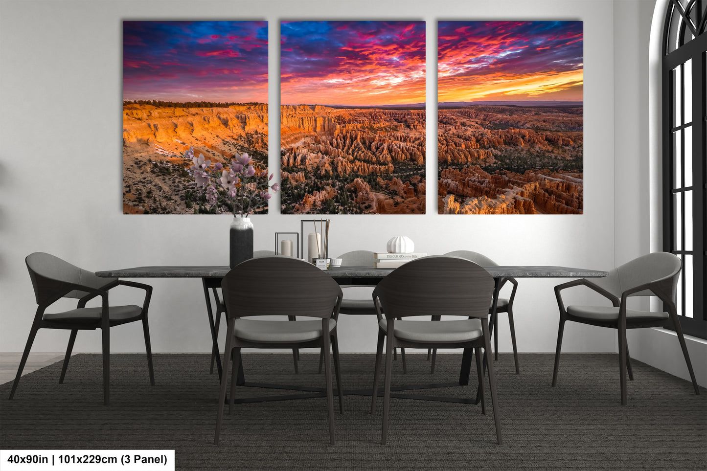 a dining room table with chairs and a painting on the wall