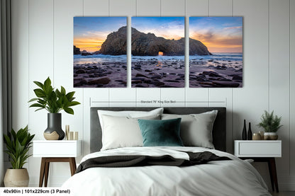 a bedroom with a bed and two paintings on the wall