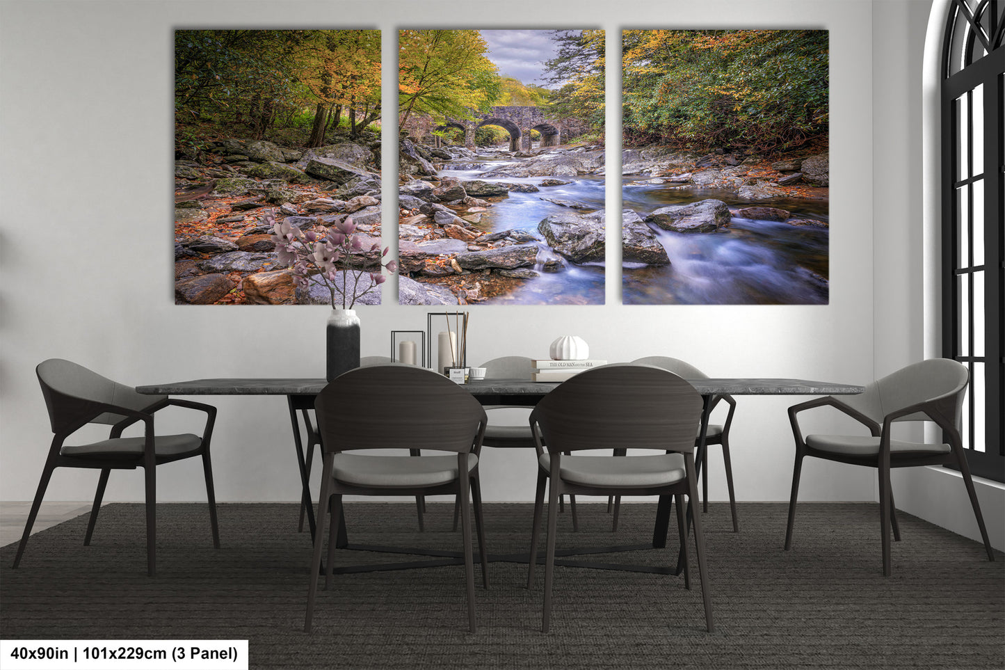 a dining room table with chairs and a painting on the wall