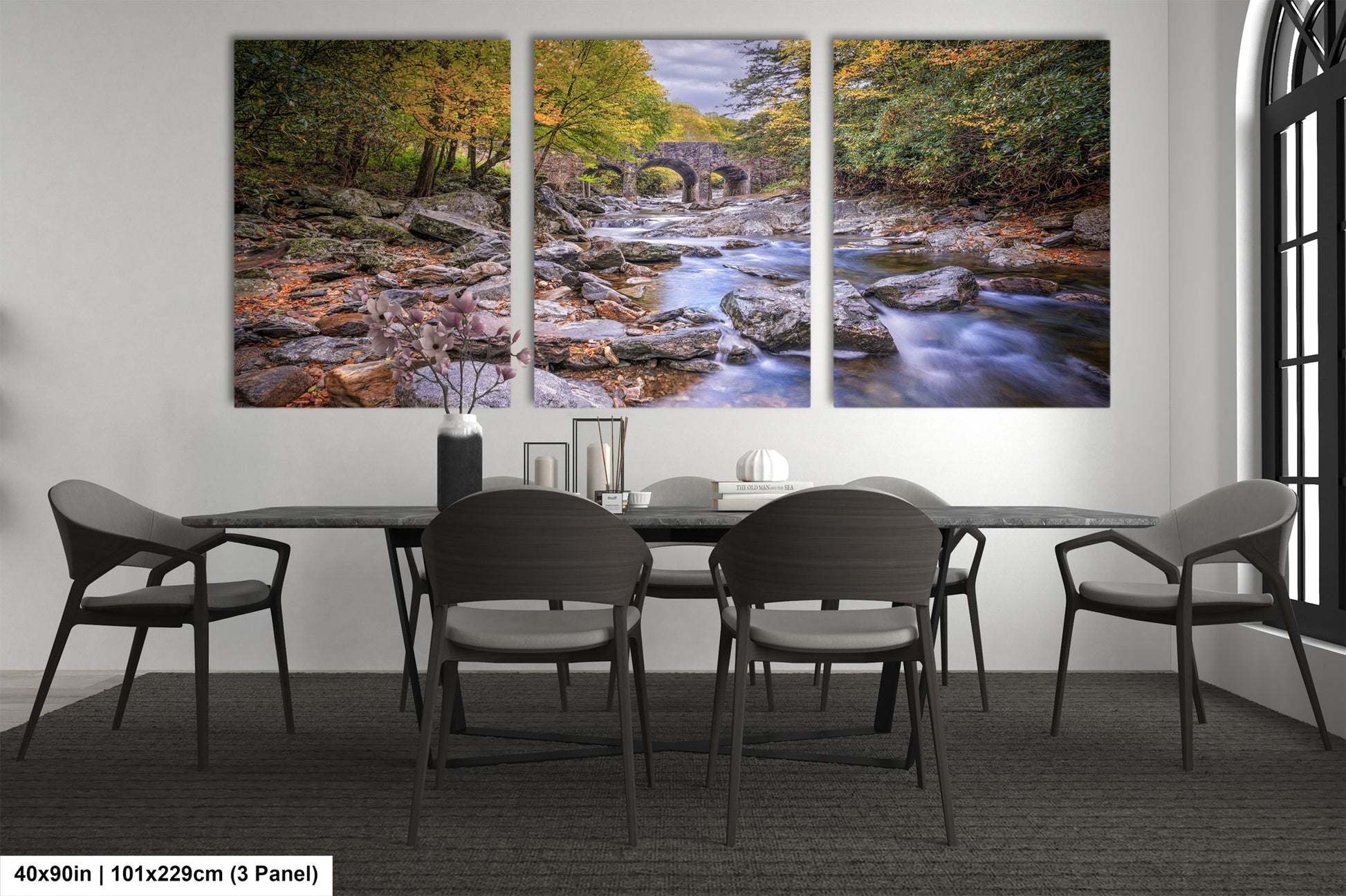 a dining room table with chairs and a painting on the wall