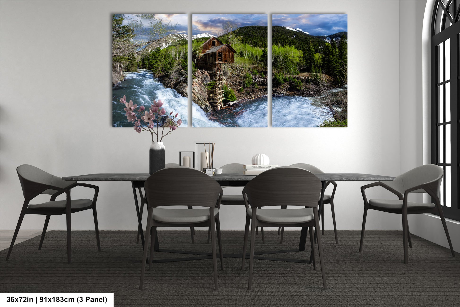 a dining room table with chairs and a painting on the wall