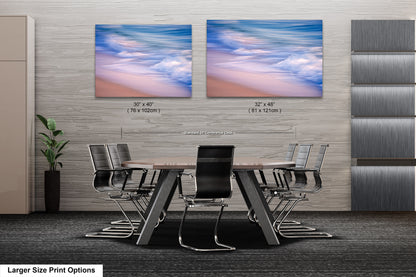 a dining room table with chairs and two pictures on the wall