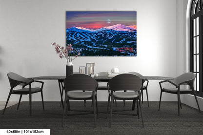 a dining room table with chairs and a painting on the wall