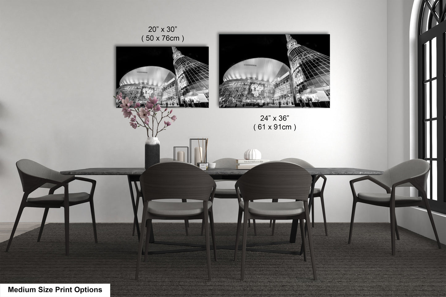 a dining table with four chairs and a vase of flowers