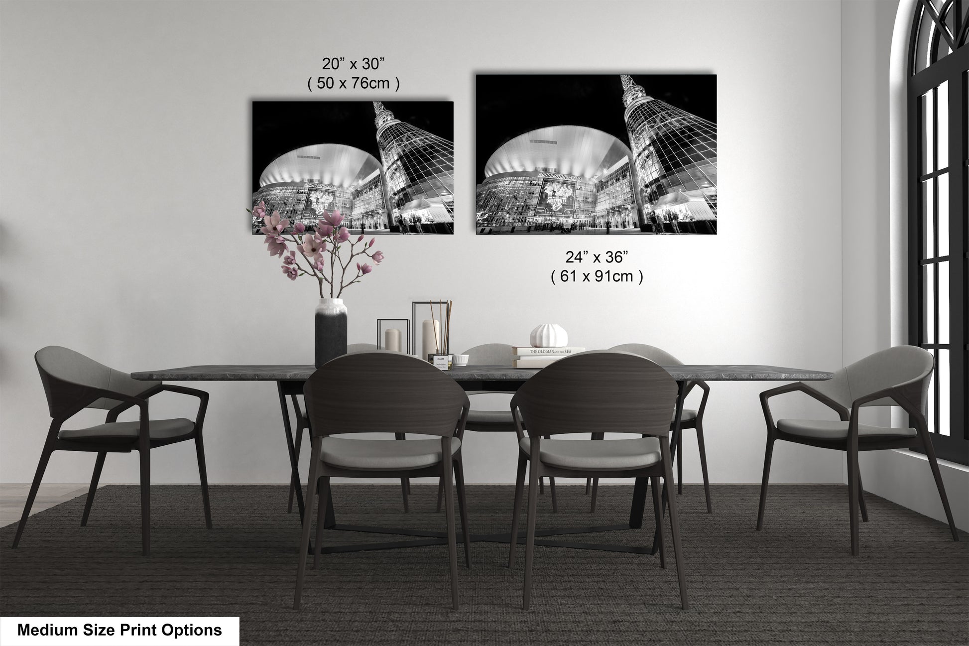 a dining table with four chairs and a vase of flowers