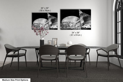 a dining table with four chairs and a vase of flowers