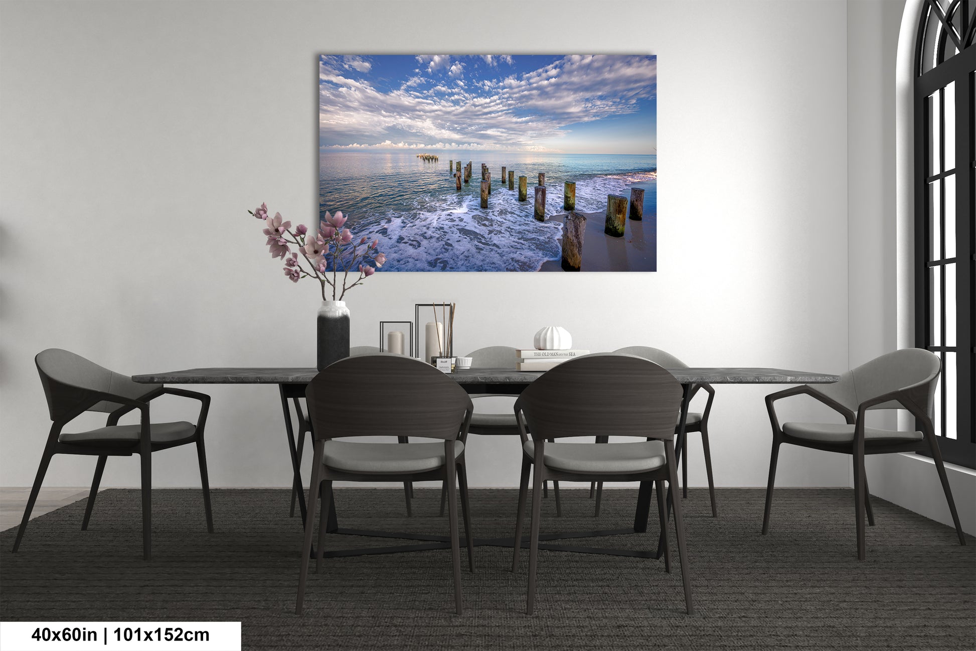 a dining room table with chairs and a painting on the wall