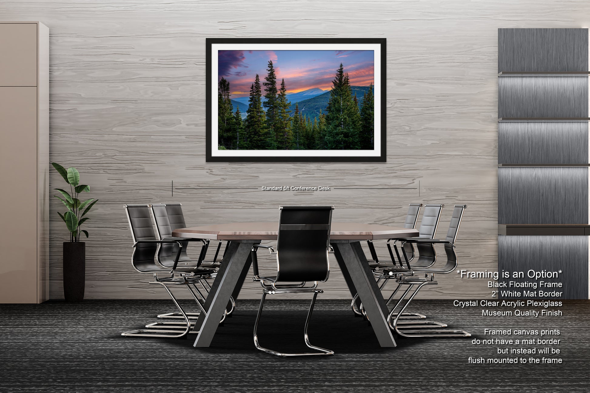 a modern office space with a large framed landscape painting hanging on the wall above a wooden table surrounded by black chairs.
