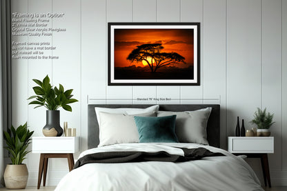 a bedroom with a bed and a picture on the wall