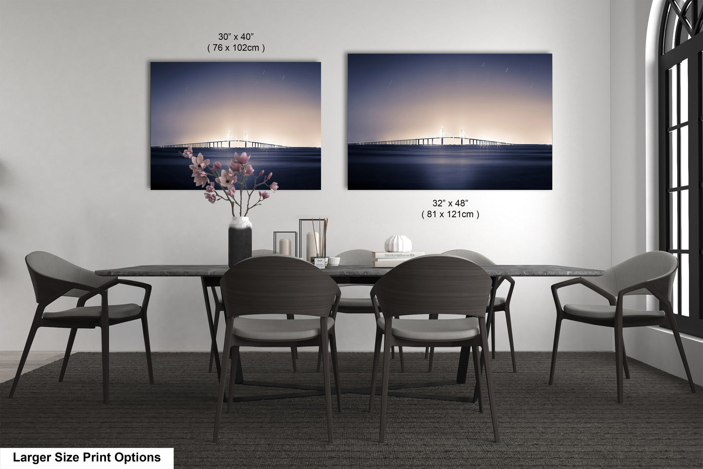 a dining table with four chairs and a vase of flowers