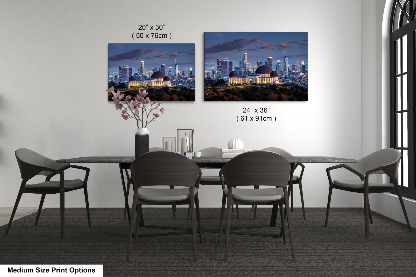 a dining room table with four chairs and a vase of flowers