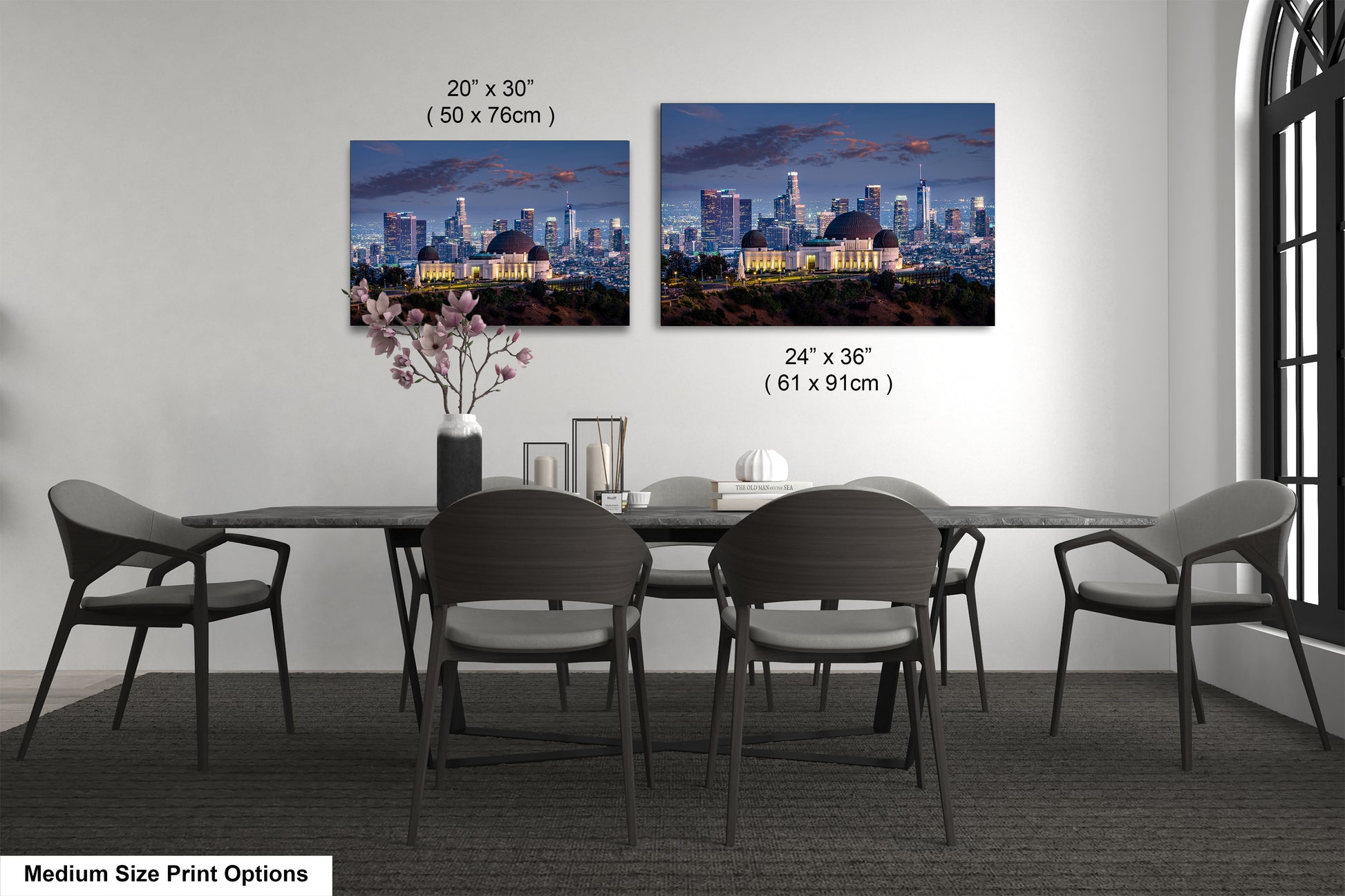 a dining room table with four chairs and a vase of flowers