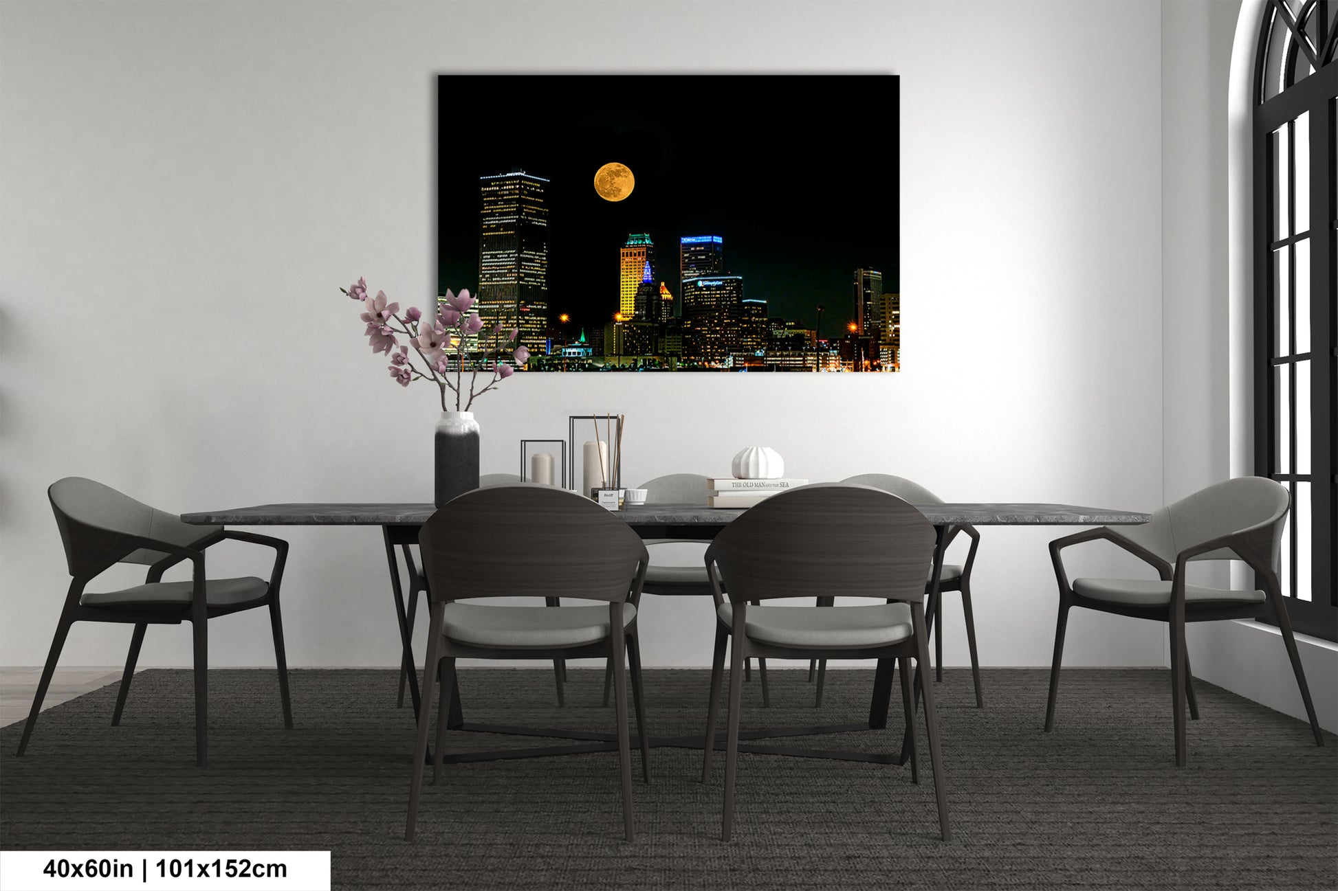 a dining room table with chairs and a vase of flowers