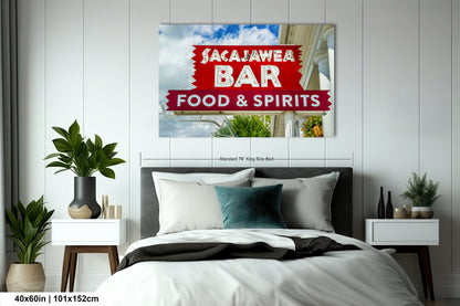 a bed room with a neatly made bed and a poster on the wall