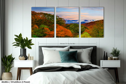 a bedroom with a bed and two paintings on the wall