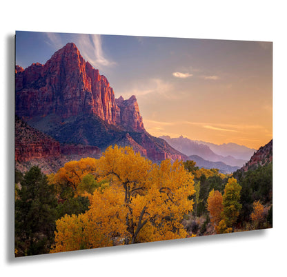 a scenic view of a mountain range at sunset