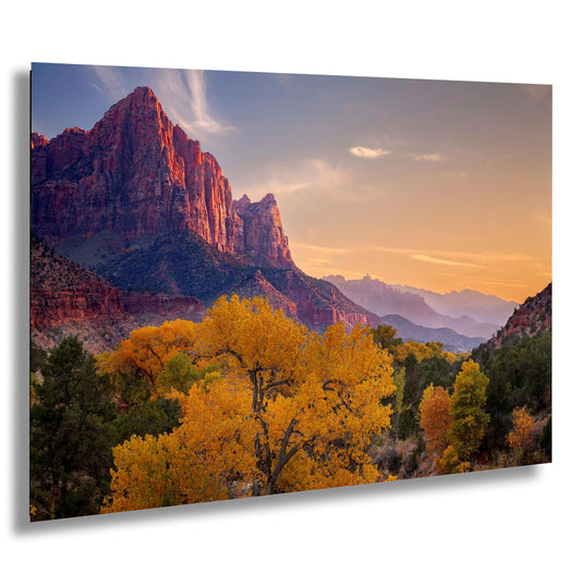 a scenic view of a mountain range at sunset