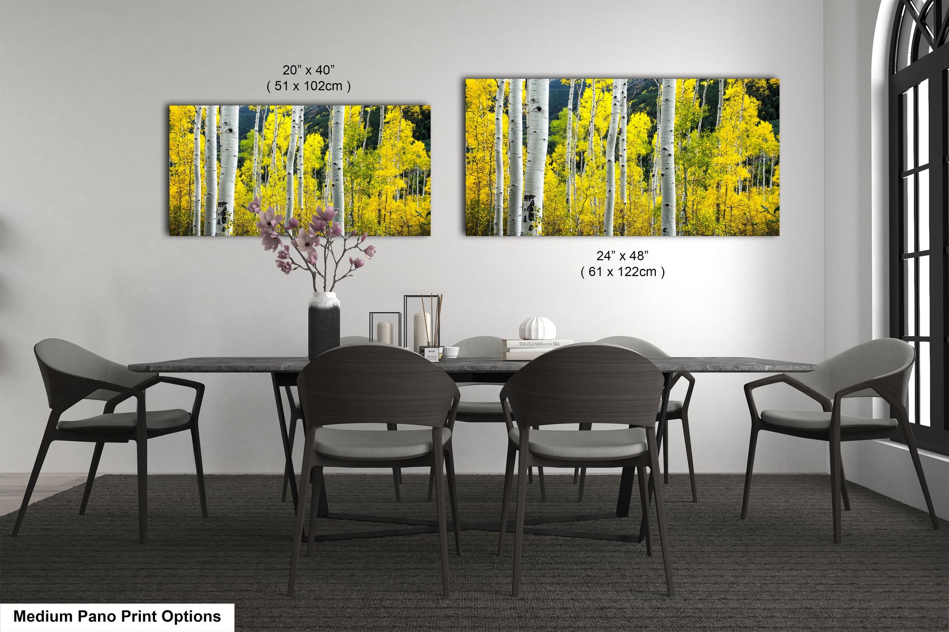 a dining room table with four chairs and a vase of flowers