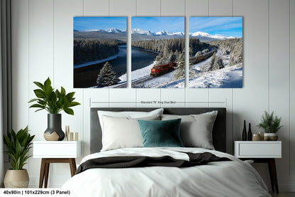 The image is a large, three-panel print depicting a snowy mountain landscape with a train traveling through it.