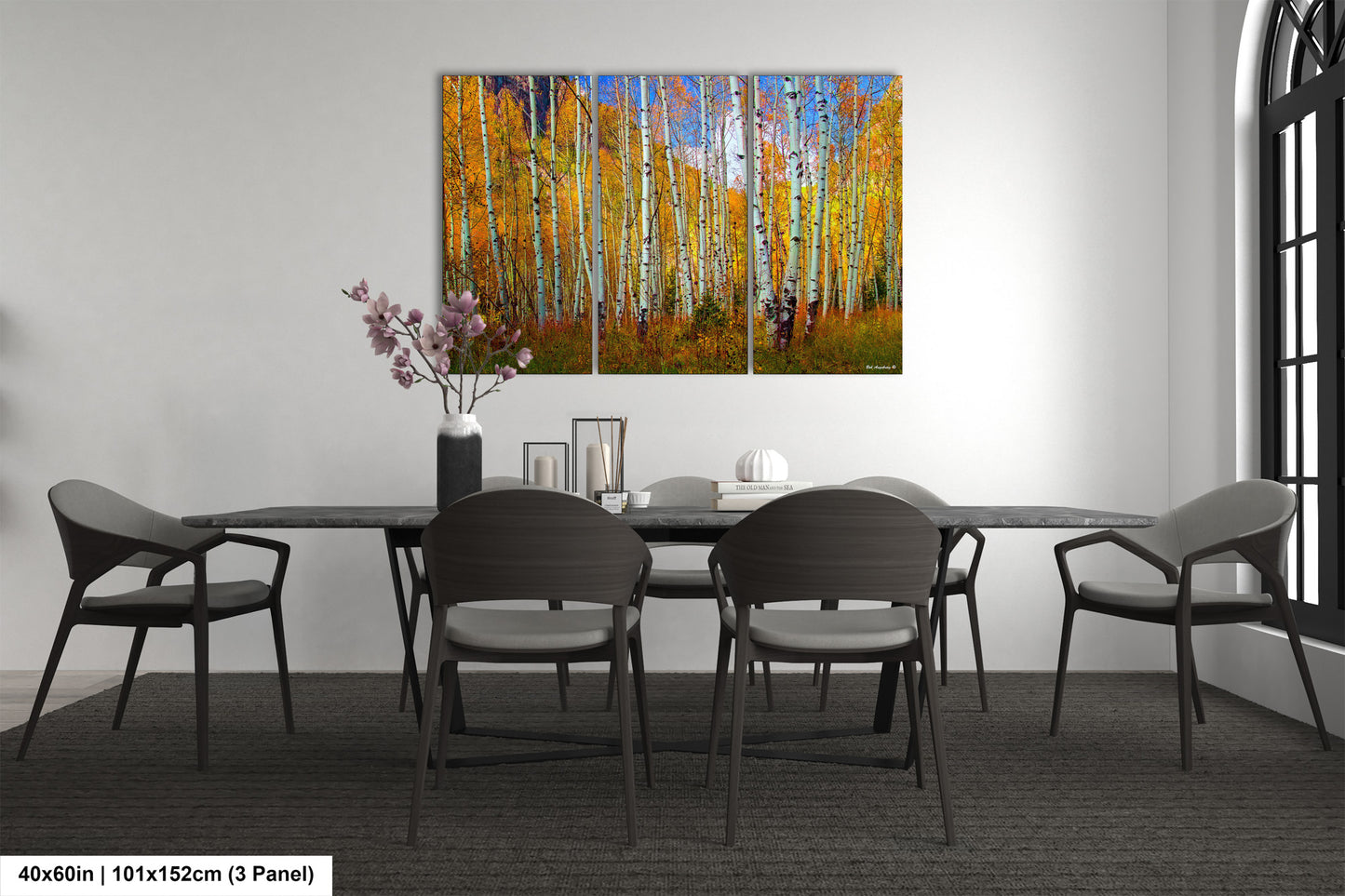 a dining room table with chairs and a painting on the wall