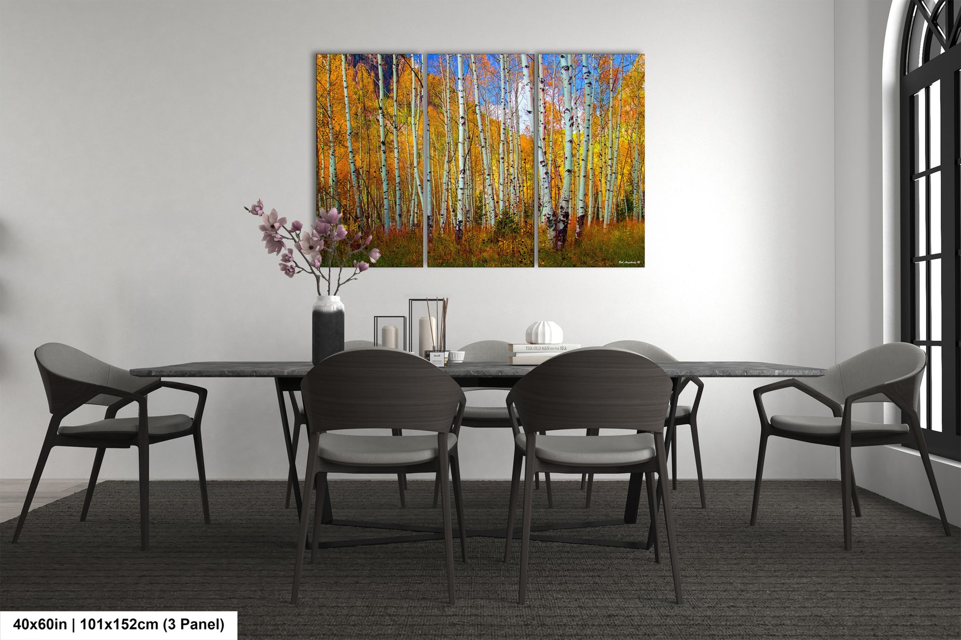 a dining room table with chairs and a painting on the wall