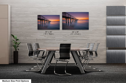 a dining room table with chairs and a picture of a pier