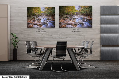 a dining room table with chairs and two pictures on the wall