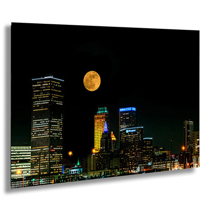 a full moon rises over a city at night