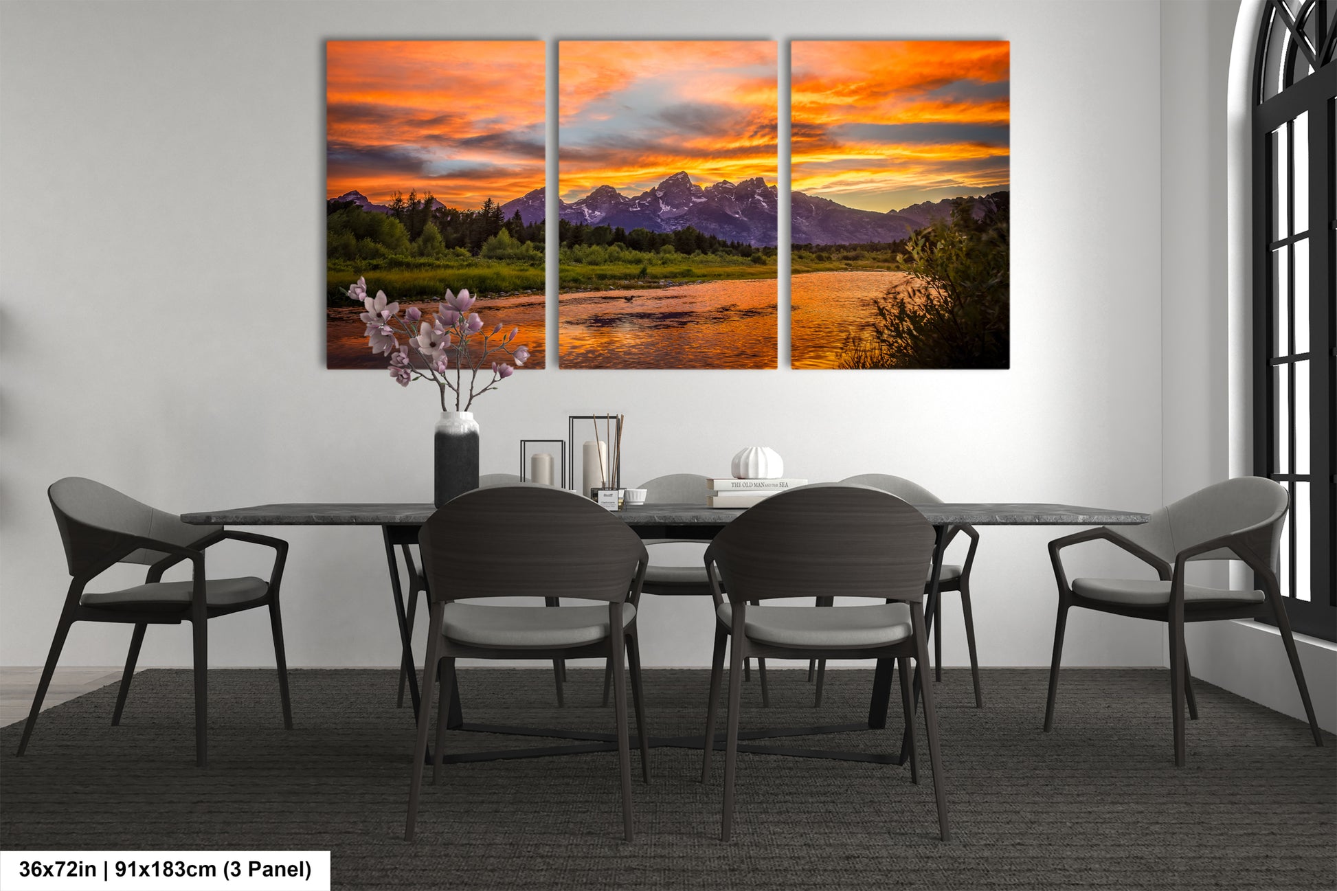 a dining room table with chairs and a painting on the wall