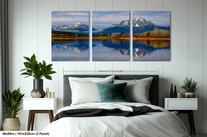 a bedroom with a large bed and two paintings on the wall