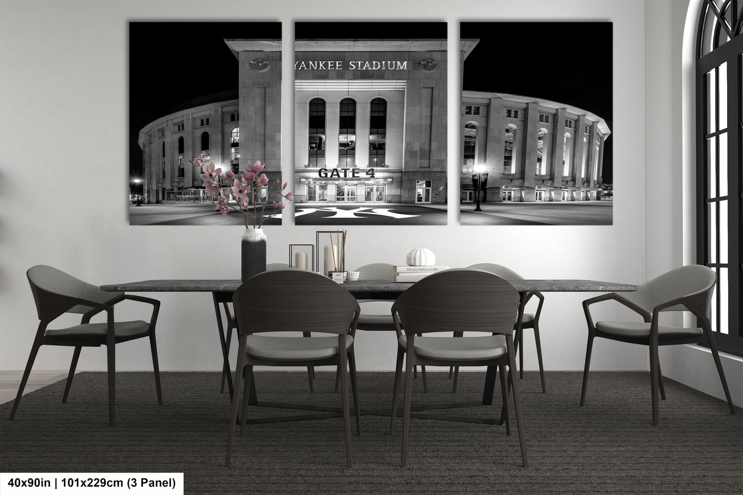 A black and white photograph of Yankee Stadium, the home stadium of the New York Yankees, with a dining table and chairs in the foreground.
