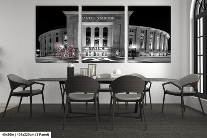 A black and white photograph of Yankee Stadium, the home stadium of the New York Yankees, with a dining table and chairs in the foreground.