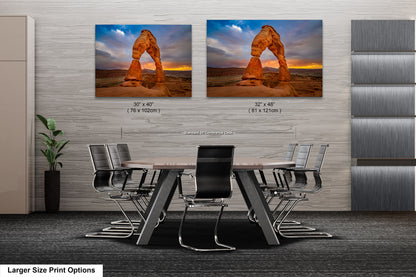 a dining room table with chairs and two pictures of a rock formation