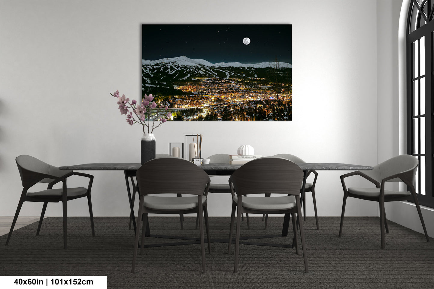 a room with a table and chairs and a painting on the wall